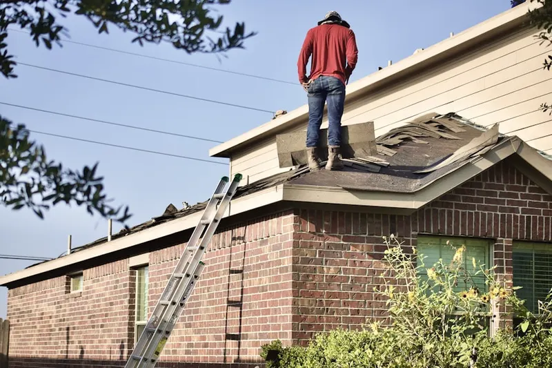 Professional roofer working on a residential roof in West Grapeland Heights